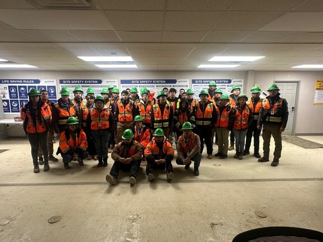 ADF crew in hard hats and hi-vis vests at a site safety briefing